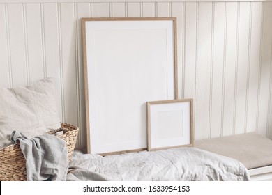 Portrait and square empty wooden frame mockups with straw basket and linen cloth. White beadboard wainscot wall paneling background. Scandinavian interior, home design. Art concept.