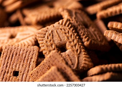 A portrait of a stack of brown cookies called speculaas or speculoos in Belgium or the Netherlands. The spiced biscuit is very delicious and popular during the winter period to be eaten at any time.