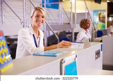 Portrait Of Staff At Airport Check In Desk