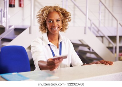 Portrait Of Staff At Airport Check In Desk