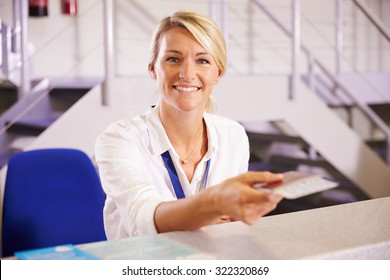 Portrait Of Staff At Airport Check In Desk