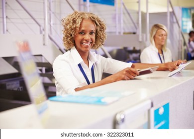 Portrait Of Staff At Airport Check In Desk