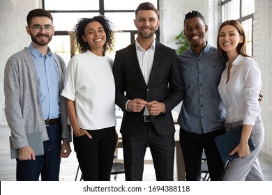 Portrait Of Standing In Row Smiling Diverse Team Looking At Camera. Happy Multiethnic Corporate Staff, Young Specialists, Company Representatives, Bank Workers Photo Shoot, HR Agency Recruitments.