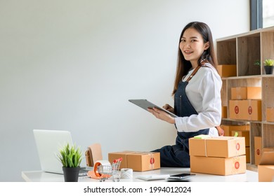 Portrait of Starting small businesses SME owners female entrepreneurs working on receipt box and check online orders to prepare to pack the boxes, sell to customers, sme business ideas online.