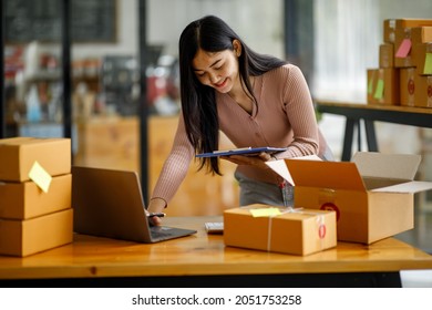 Portrait Of Starting Small Businesses SME Owners Female Entrepreneurs Working On Receipt Box And Check Online Orders To Prepare To Pack The Boxes, Sell To Customers, Sme Business Ideas Online.