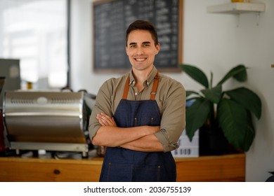 Portrait of Startup successful small business owner in coffee shop.handsome man barista cafe owner. SME entrepreneur seller business concept