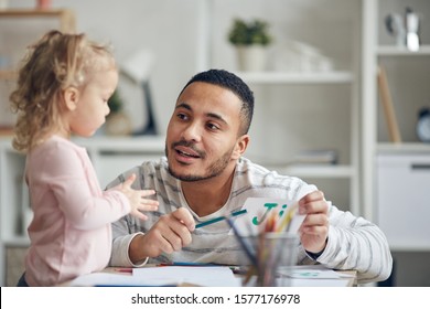 Portrait Of Stay At Home Dad Learning Alphabet With Cute Little Daughter At Home, Copy Space