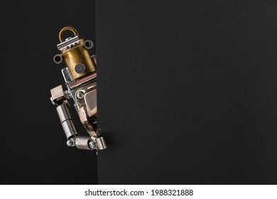 Portrait of a steampunk robot looking around the corner of a black empty board with space for copy