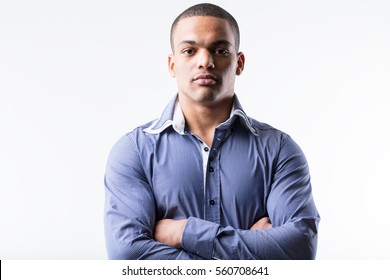 Portrait Of A Stern Afro-american Man On A Blue Shirt, Studio Portrait On A White Background