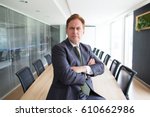 Portrait of stern senior businessman in boardroom