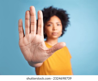 Portrait, stop hand sign and woman in studio isolated on a blue background mockup space. African person, face and ban, rejection or warning, refuse or no palm to protest racism, human rights or emoji - Shutterstock ID 2324698739