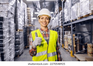 Portrait of a storage worker giving thumbs up while smiling at the camera. - Powered by Shutterstock