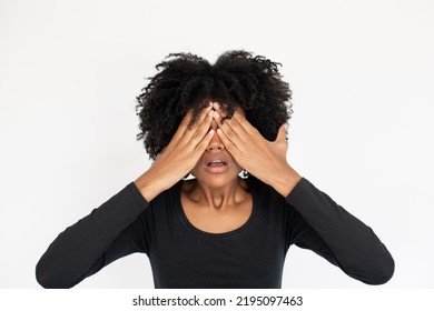 Portrait Of Stressed African American Woman Covering Eyes In Fear. Young Female Model Wearing Black Dress Rubbing Eyes. Depression And Terror Concept