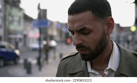 Portrait of a stressed Arab young man standing in stress feeling worry and anxiety. One Middle Eastern male person suffering from mental distress and regret - Shutterstock ID 2290853213