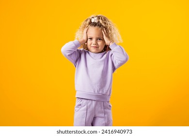 Portrait of Stressed child girl holding her head. Negative emotions concept