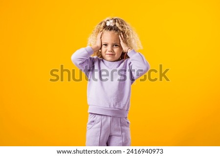 Portrait of Stressed child girl holding her head. Negative emotions concept