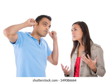 A portrait of a stressed couple going through hard times in their relationship, isolated on a white background . Young woman trying to explain something to a man , he is annoyed and closes his ears.