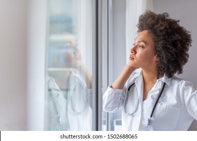Portrait of stressed doctor woman in office. People, medicine, healthcare and sorrow concept - Sad female nurse at hospital corridor. Emotional stress of young doctor - Powered by Shutterstock