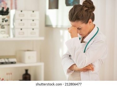 Portrait Of Stressed Doctor Woman In Office