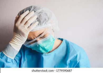 Portrait Of Stressed Healthcare Worker Woman Tired From Work Long Time In Hospital During Covid-19 Pandemic Outbreak. Conceptual Of Healthcare Worker Woman Having Negative Feelings.