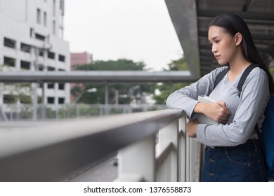 Portrait Of Stressed, Serious, Pensive, Thoughtful Asian Woman College Student Thinking In City Campus Environment