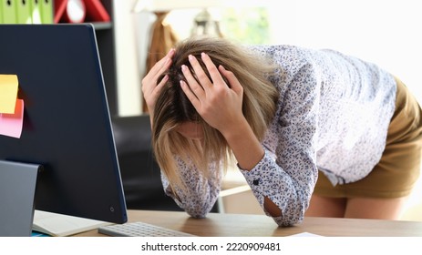 Portrait Of Stressed Woman Holding Head With Hands In Office. Upset Businesswoman Bend Over Table. Bad Day Or Job Burnout Concept