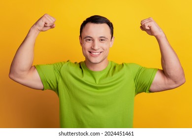 Portrait Of Strong Guy Show Big Biceps Muscle Sport Concept On Yellow Background