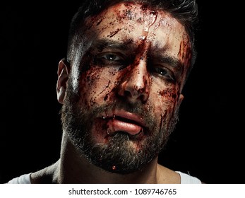 Portrait Of A Strong Man With A Beard, Face In Blood. He Looks At The Camera With Different Emotions. Blood And Sweat Dripping Down His Face. Fists Erased From Strikes