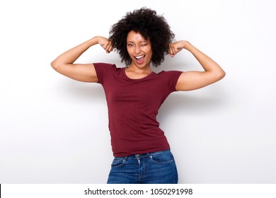 Portrait Of Strong Young African Woman Flexing Both Arms Muscles And Winking On White Background