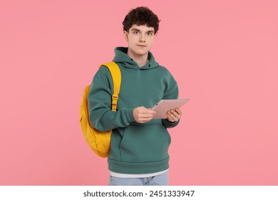 Portrait of student with backpack and tablet on pink background - Powered by Shutterstock