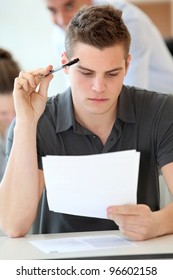 Portrait Of Student Boy Doing Written Exam