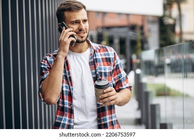 Portrait Of Student Boy Drinking Coffee And Using Phone