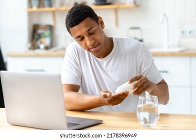 Portrait of student or freelancer man taking pills. Headache, vitamins for mental activity, healthy lifestyle concept - Powered by Shutterstock