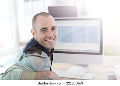 Portrait of student in front of desktop computer