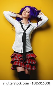 Portrait of a student girl with purple hair  posing at studio. Japanese style anime. 