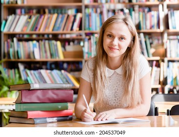 Portrait Of A Student Girl Studying At Library