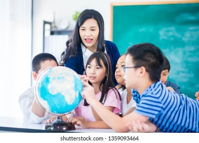 Portrait student looking at globe while listening to teacher with magnifying glass  - Powered by Shutterstock