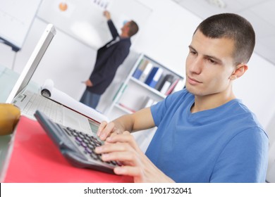 Portrait Of Student Using Calculator