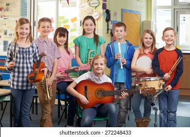 Portrait Of Students Playing In School Orchestra Together - Powered by Shutterstock