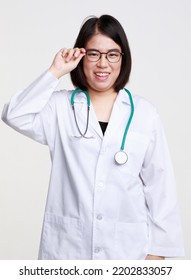 Portrait Studio Isolated Cutout Closeup Shot Of Asian Professional Successful Female Doctor In Lab Coat With Stethoscope Smiling Look At Camera Holding Hand Adjusting Eyeglasses On White Background.