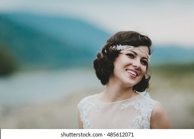 Portrait Of Stunning Bride With Short Black Hair Standing By The River