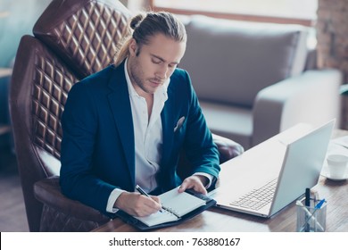 Portrait Of Stunning Busy Director Sitting At His Desk In Work Station, Holding Pencil In Hand, Writing A Date Of Conversation In Reminder, Organizing His Day