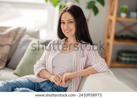 Portrait of stunning peaceful person sit comfy sofa beaming smile chilling pastime weekend house inside