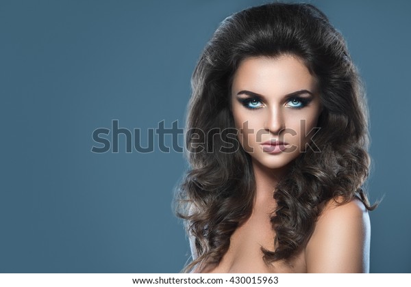 Portrait of a stunning woman with beautiful makeup\
and hairdo