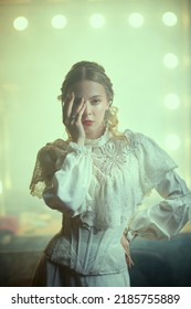 Portrait Of A Stunning Young Woman Wearing A Feminine White Dress In 19th Century Style. Victorian Style. Vintage Interior. 