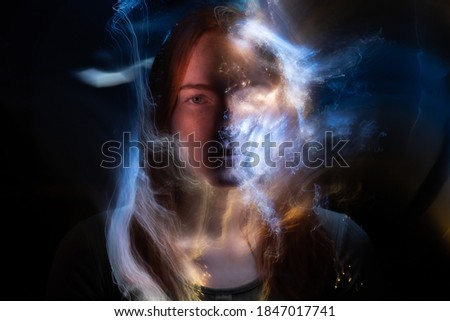 Similar – Artistic portrait of a brunette woman with a light effect