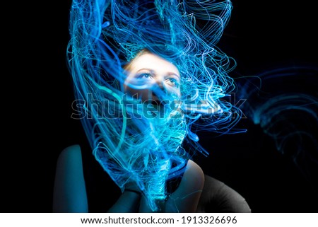 Similar – Beautiful young woman posing with blue makeup