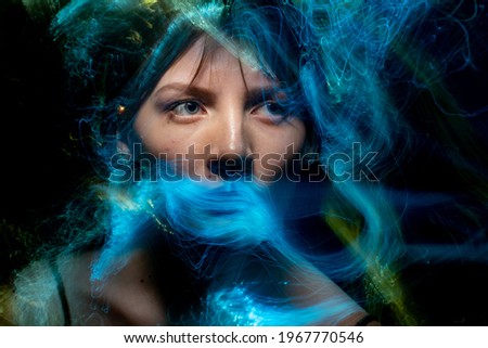 Similar – Abstract portrait of a young woman looking at camera