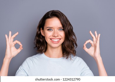 Portrait Of Style Stylish Lady With Her Curly Brunette Hair Beaming Hollywood Smile She Gives Ok-sign On Two Hands Stand Isolated On Gray Wall