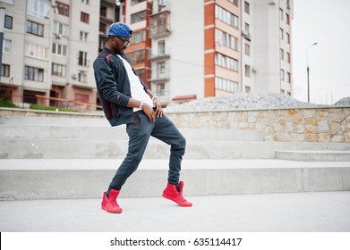 Portrait Of Stylish African American Man On Sportswear, Cap And Glasses. Black Men Model Street Fashion, Dancing Hip Hop.